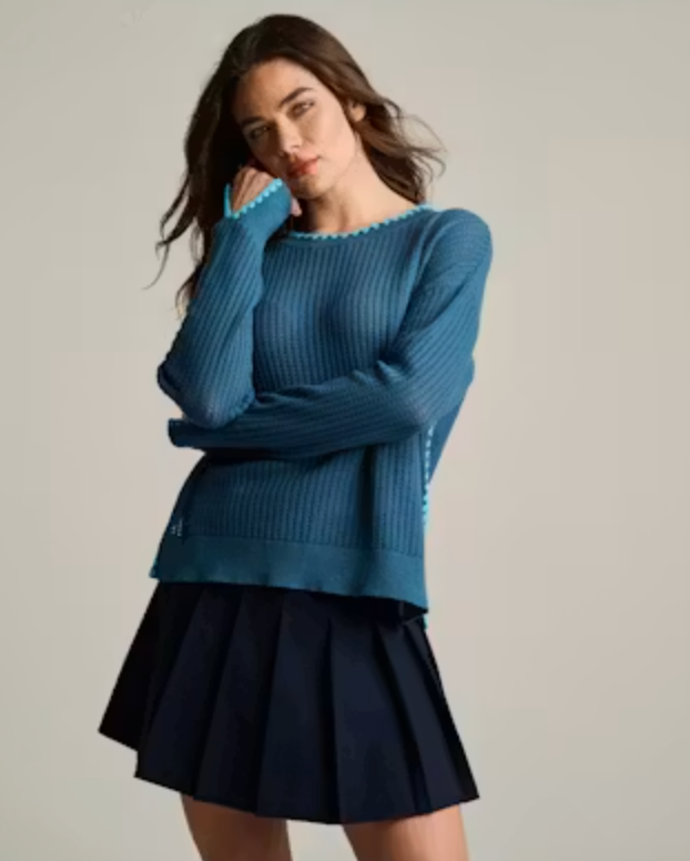Front on-model — Lisa Todd Power Stitch Sweater, ribbed knit with contrast picot trim, worn with pleated mini skirt