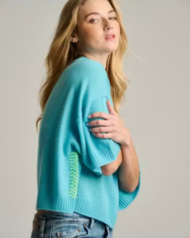 Side on-model — Lisa Todd Crew Mate Sweater in Blue Magic, cropped boxy cashmere sweater with contrast whipstitch seam, worn with denim
