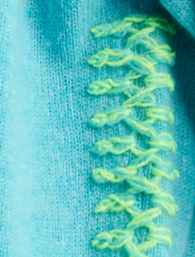 Detail close-up — Lisa Todd Crew Mate Sweater in Blue Magic, neon whipstitch seam detail on cashmere knit