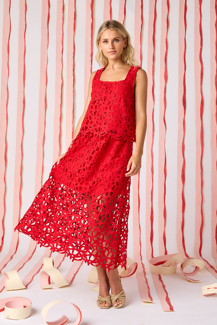 Crosby Selene Lace Skirt in Pomegranate showing transition from lined geometric crochet lace body to open, wider-pattern unlined lace hem border with scalloped edge- shown here paired with a matching top