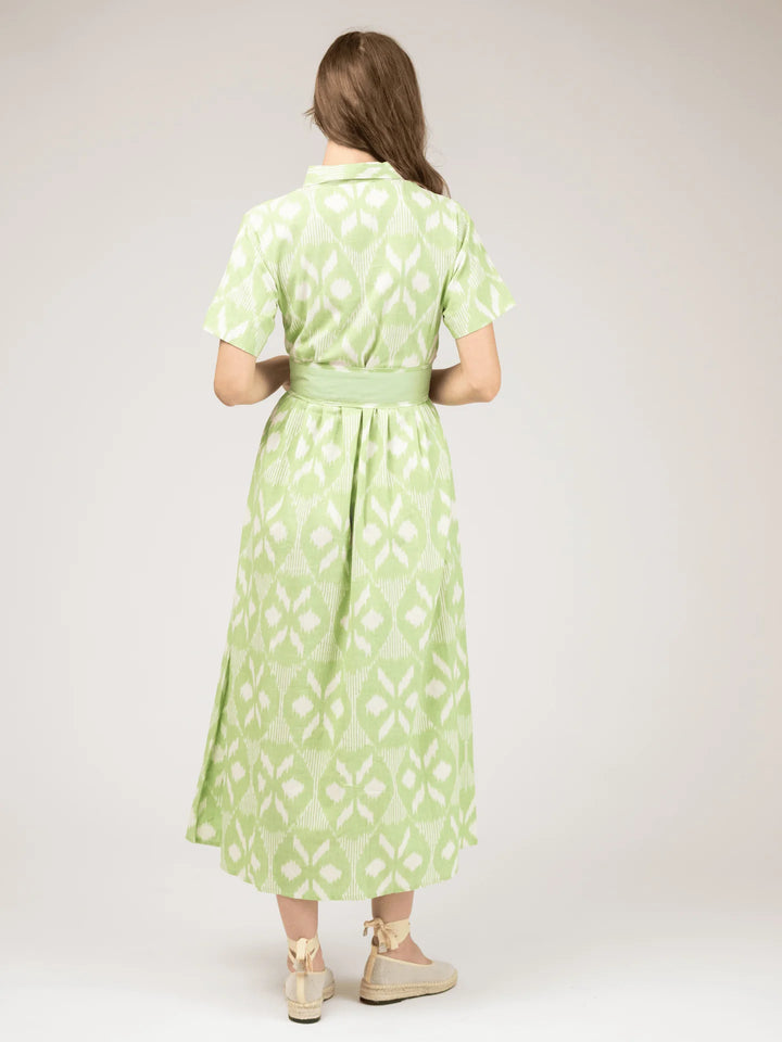 Beau &amp; Ro Elle Maxi Dress in Lime Ikat — back view showing button placket continuing through skirt, solid matching tie belt with center-back pleating at waist, short sleeves with clean hem.