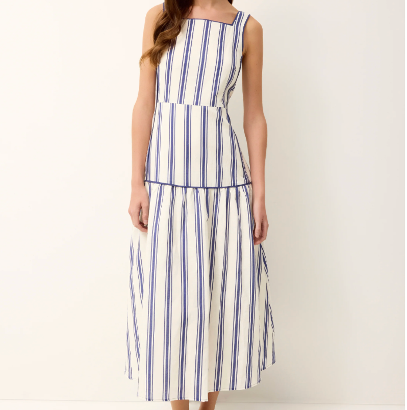 Woman wearing a blue and white striped dress on a white background