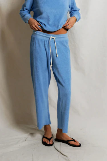 Close-up of Pacific blue loop terry fabric texture and natural rope drawcord at waistband, cropped ankle hem visible — perfectwhitetee Eliana Capri Pant