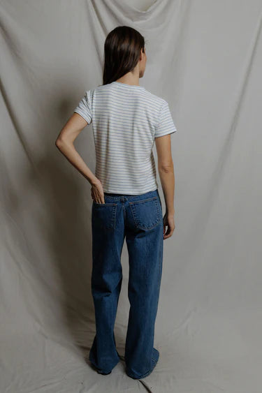 Back view of white and blue stripe brushed v-neck tee showing relaxed cropped silhouette and short sleeve hem, paired with wide-leg denim — perfectwhitetee Elliot Pacific Stripe Tee