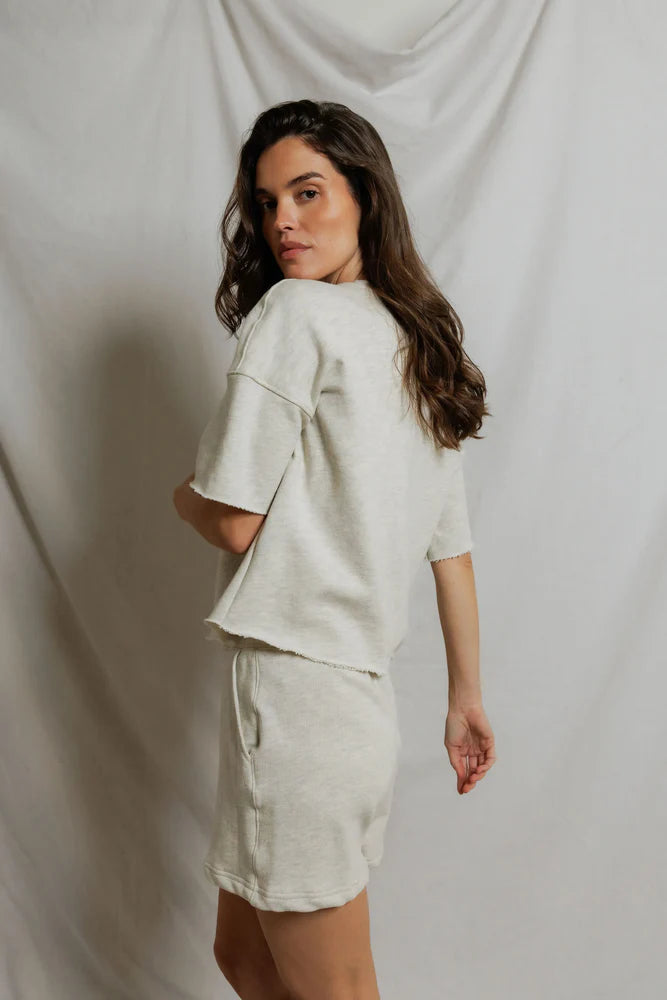 Side of perfectwhitetee Ezra French Terry Short Sleeve Top in Oatmeal, relaxed boxy fit with drop shoulders and rolled hem
