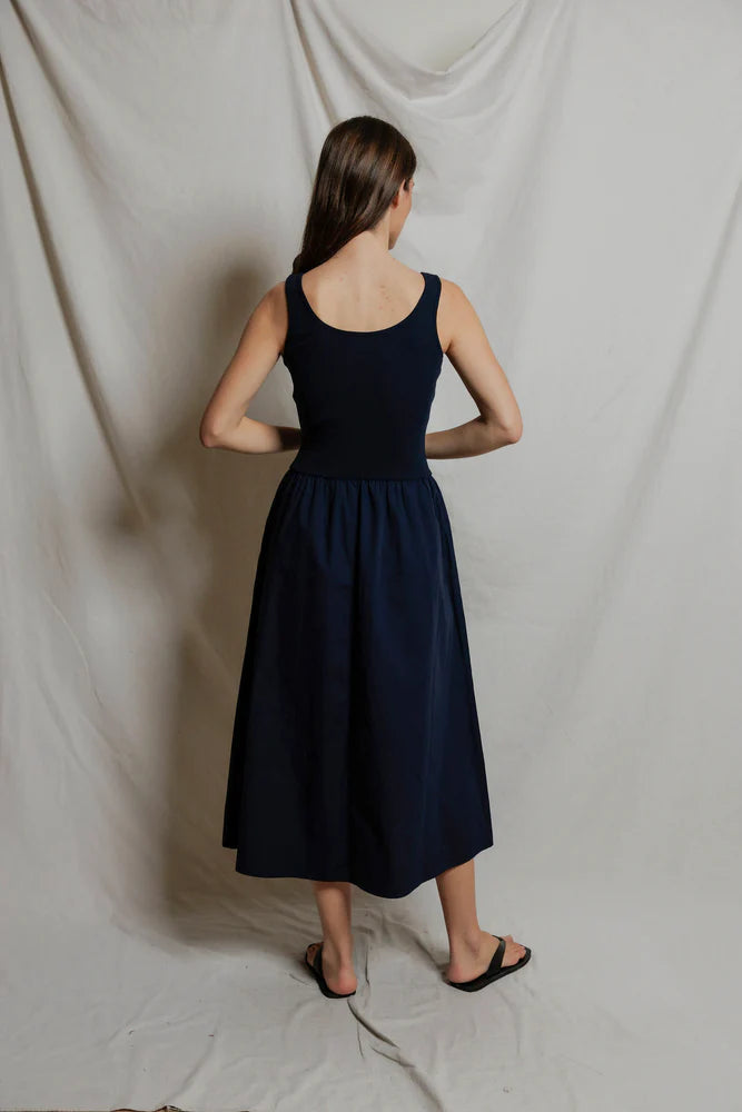 Image of model in Fabiola Cotton Poplin Sleeveless Dress in Navy by perfectwhitetee facing back