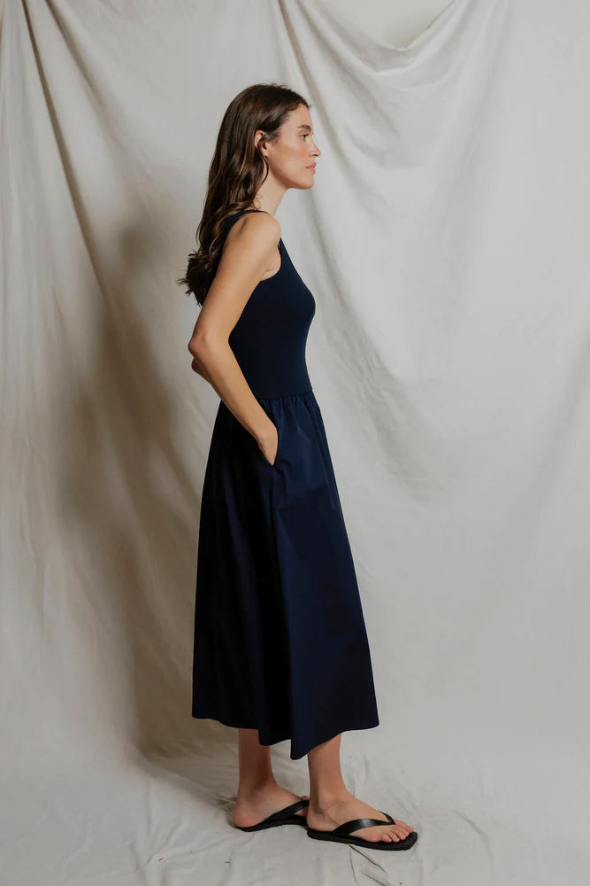 Image of model in Fabiola Cotton Poplin Sleeveless Dress in Navy by perfectwhitetee facing sideways