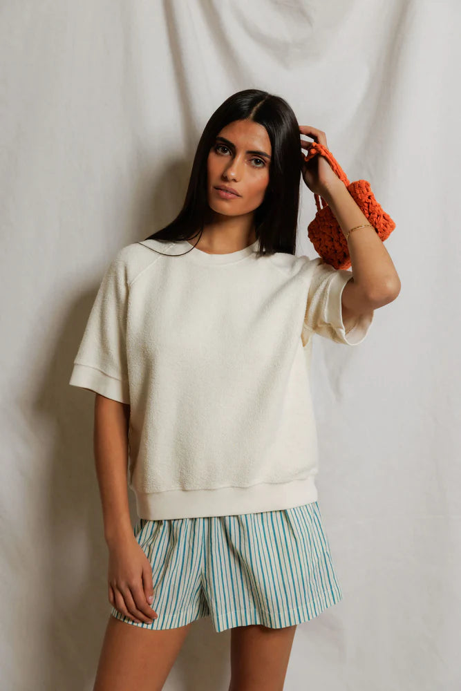 This Kennedy Sweatshirt by perfectwhitetee carries the signature fleece feel into a short-sleeve silhouette — raglan sleeves, a crew neckline, and a relaxed body - shown on model with shorts.