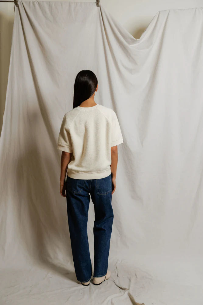 This Kennedy Sweatshirt by perfectwhitetee carries the signature fleece feel into a short-sleeve silhouette — raglan sleeves, a crew neckline, and a relaxed body - shown on model in jeans facing back.