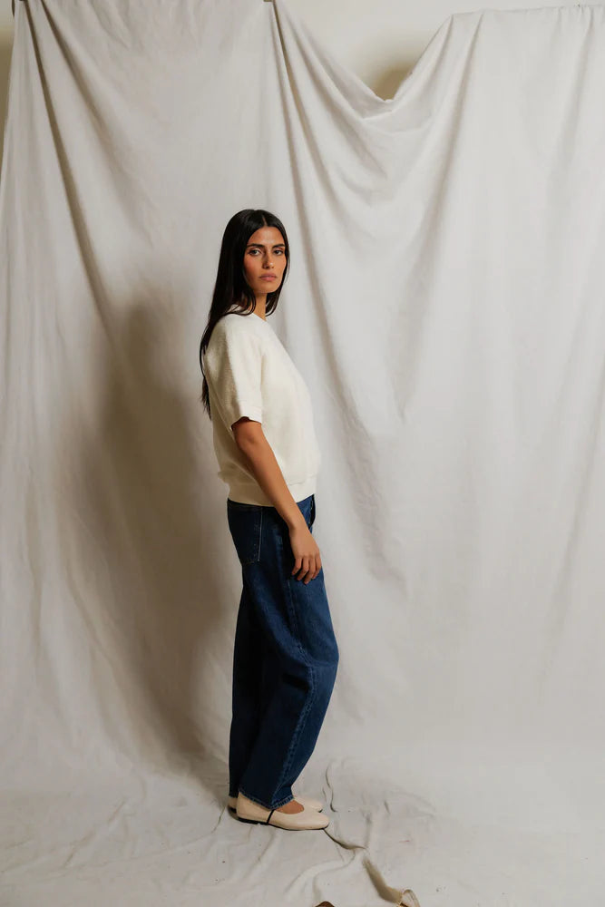 This Kennedy Sweatshirt by perfectwhitetee carries the signature fleece feel into a short-sleeve silhouette — raglan sleeves, a crew neckline, and a relaxed body - shown on model in jeans facing sideways.
