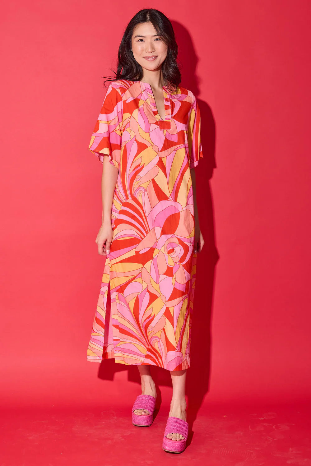 Front view of model wearing the Alden Adair Delaney Dress in Moroccan Poppy, highlighting the abstract floral print.