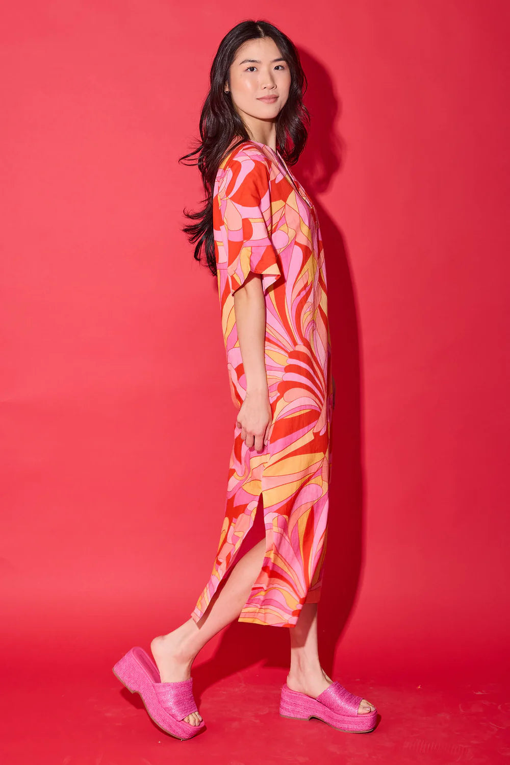 Side view of the Alden Adair Delaney Dress in Moroccan Poppy, showing the flowing silhouette and side slit.