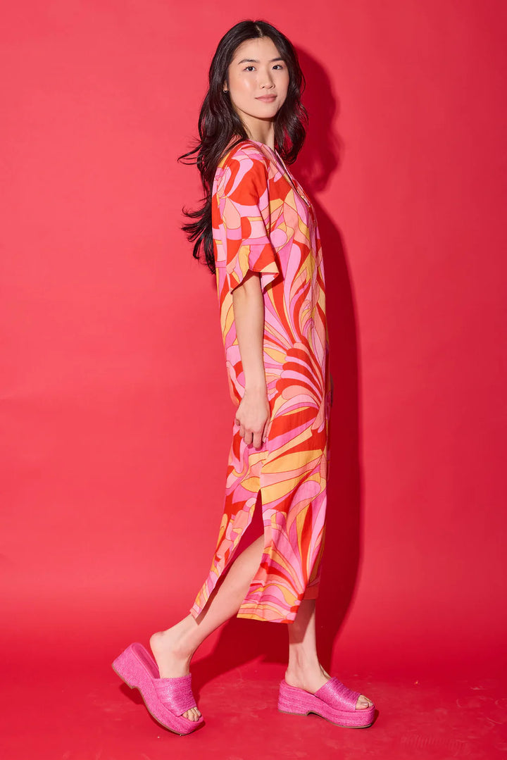 Side view of the Alden Adair Delaney Dress in Moroccan Poppy, showing the flowing silhouette and side slit.