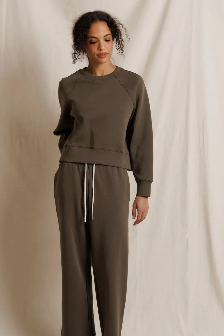 perfectwhitetee Nell Pureform Raglan Sweatshirt in dark olive — front view styled with matching olive joggers