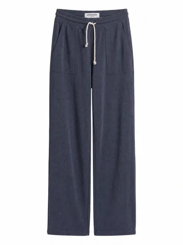 Product flat lay of slate blue French terry pants with rope drawcord and front pockets.