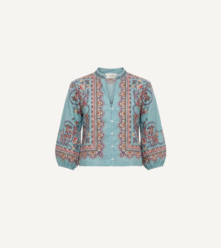 Model wearing teal paisley print, cropped relaxed fit with button-front closure and band collar.