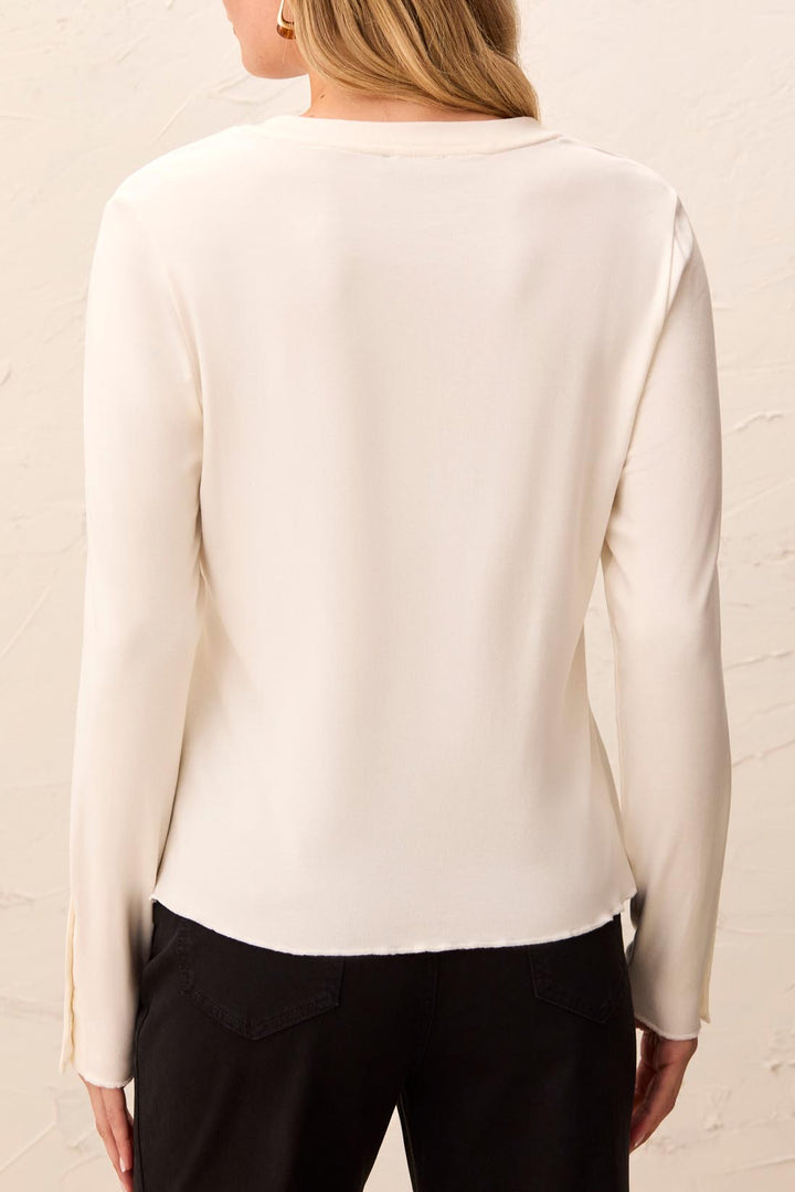 Tribal Long Sleeve Crew Neck Top with Button Detail in Moonstone, back view on model, showing clean back, lettuce-edge hem, and split cuffs.