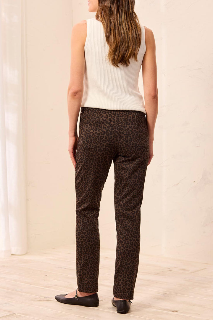 Tribal Pull On Ankle Pant with Pockets in Hickory, back view on model, showing back patch pockets, elastic waistband, and slim tapered leg in leopard print.