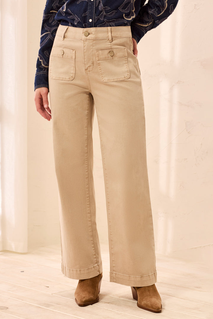 Tribal Sophia Curvy Super Straight Ankle in Light Suede, front close view on model, showing high rise, button closure, belt loops, and front patch pockets with button tabs, worn with suede ankle boots.