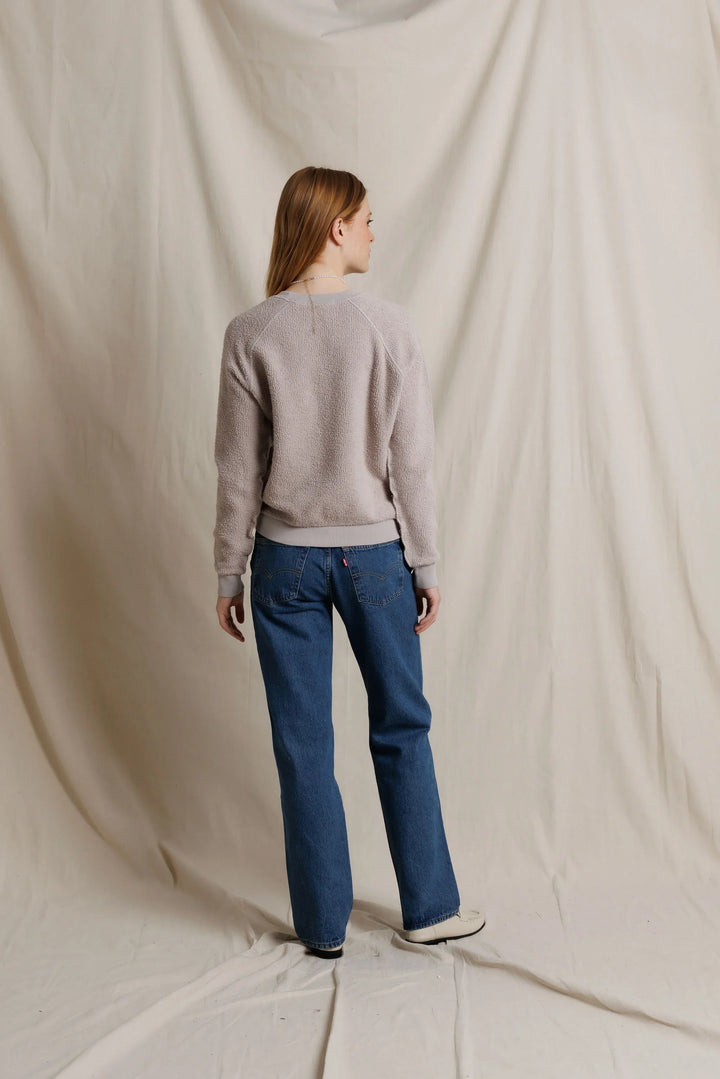 perfectwhitetee Ziggy Inside Out Fleece Sweatshirt in Cloud Gray, full-length back view on model, showing raglan seams, ribbed hem at the high hip, and ribbed cuffs, styled with straight-leg jeans and cream loafers